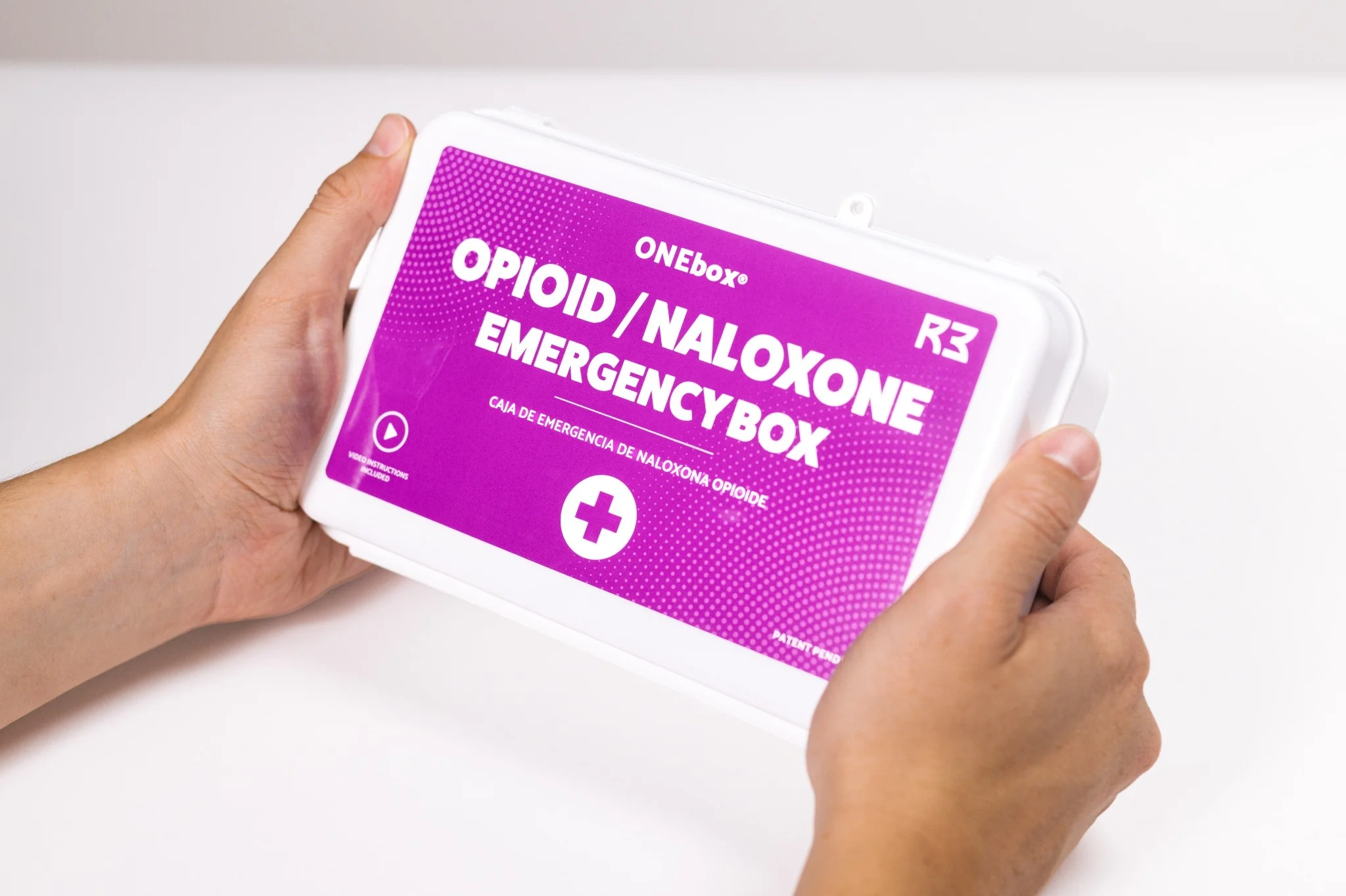 Two hands holding a ONEbox.